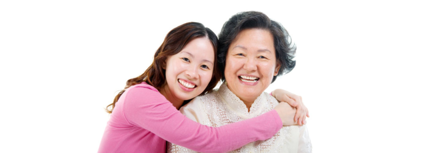 caregiver hugging a senior woman